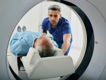 tech guiding a man into MRI
