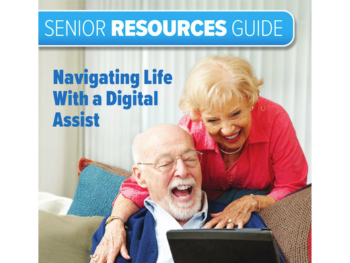 older man and woman smile at tablet