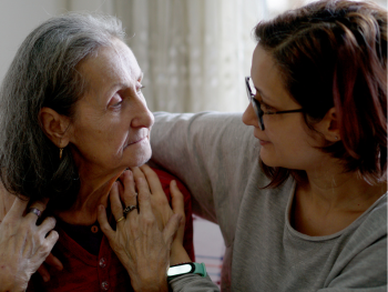 woman and aging mother embrace