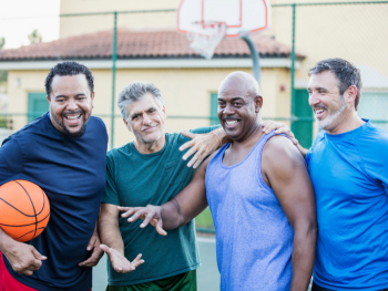 group of 4 older men after playing basketball