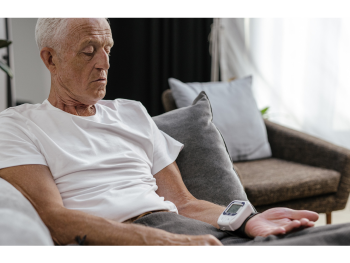 man uses home blood pressure monitor