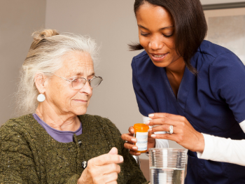 caregiver helps client with medication