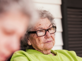 older woman stares blankly ahead