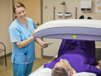 nurse administers a dexa scan