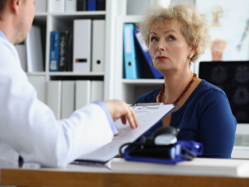 woman looks annoyed while speaking to doctor