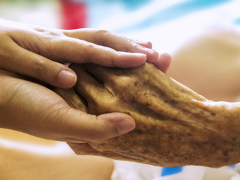 young hands holding elderly hand