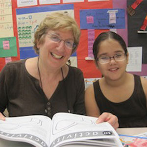 smiling volunteer with student