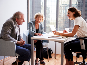 lawyer sits with older couple