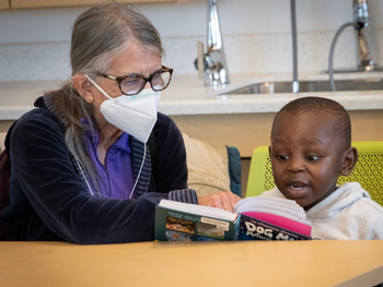 volunteer reads with a child