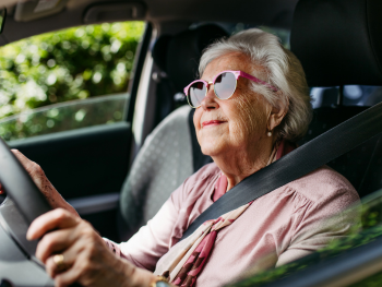 older woman gripping steering wheel