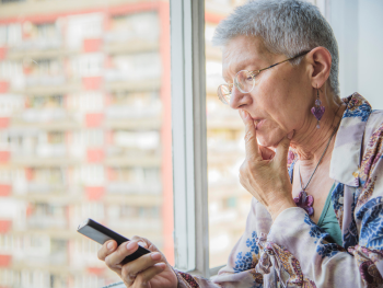 woman looks at cell phone suspiciously