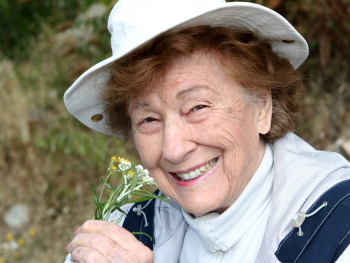 smiling woman holding wildflowers