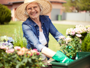 woman with a large sunhat gardening