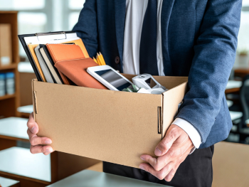 man carries box of desk contents