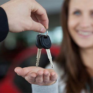 young woman receiving car keys
