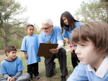 senior volunteer coach with kids