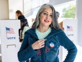 woman wears an "I Voted" button