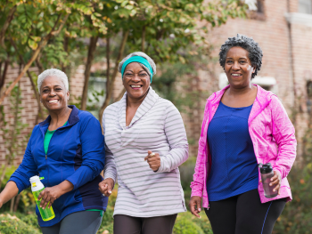 three smiling women out for a brisk walk