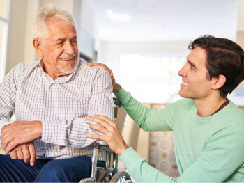 man in wheelchair smiles at companion